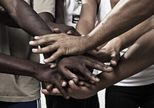 Closeup portrait of group with mixed race people with hands together